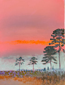 Tall Pines and bright orange sky over the marsh